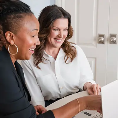 JennNeuman-Consulting Jenn Neuman seated a a table consulting a client
