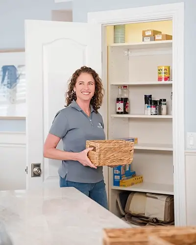 Neu-Spaces-Pantry-Organization-tall NEU Spaces team member organizing a pantry