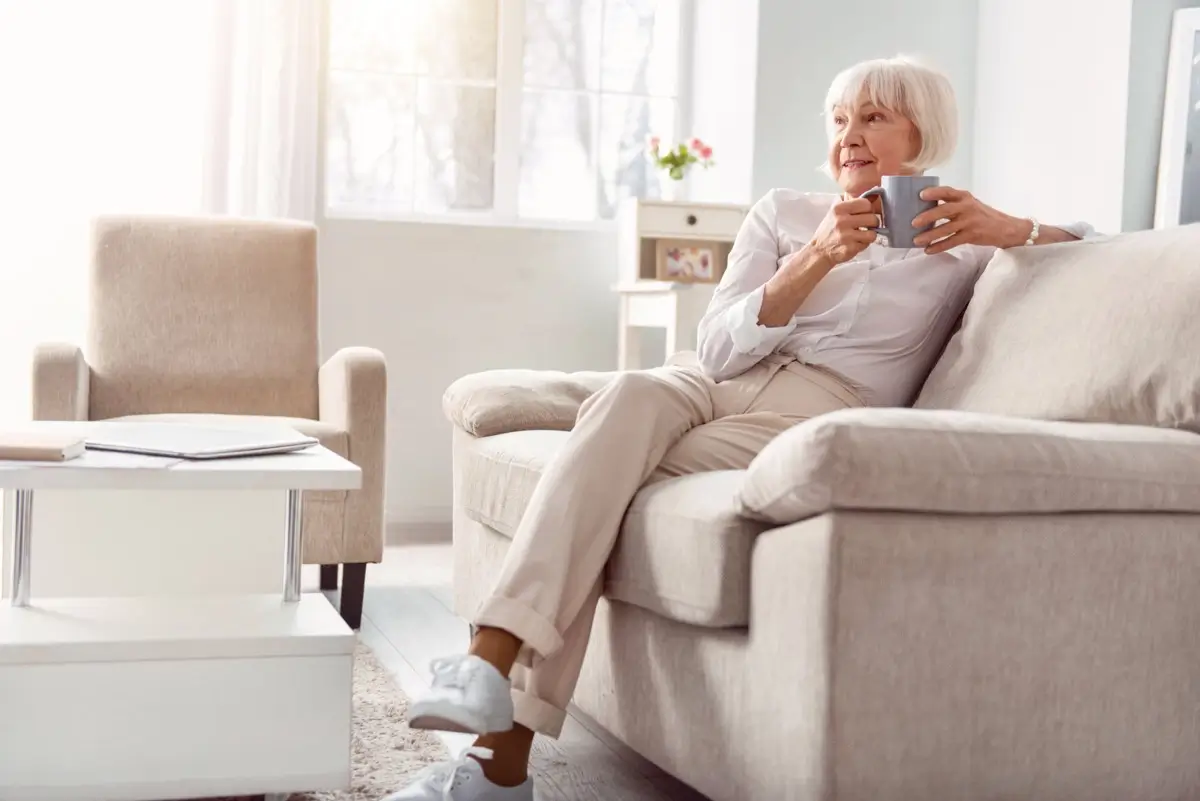Older women having a good time playing cards at home